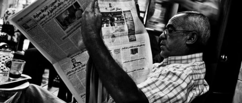 man reading newspaper